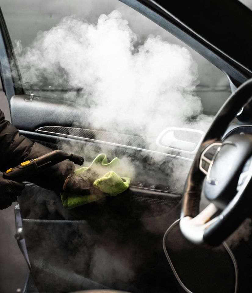 Wiping down inside of car with steam and cloth