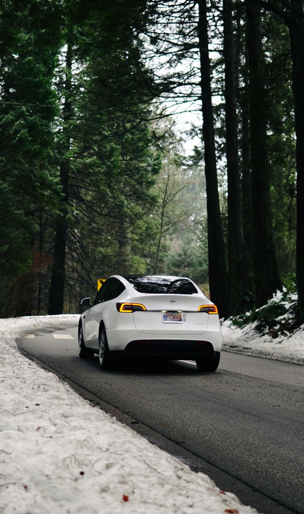 White Porsche going down windy road