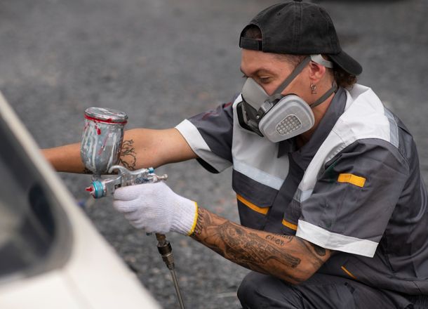 Man painting on car